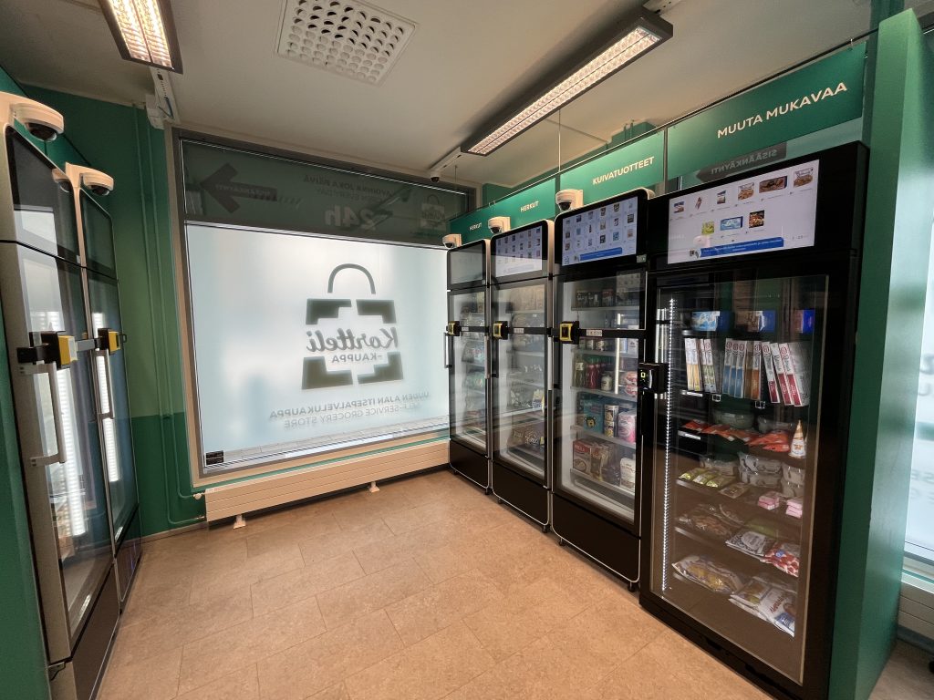 Four vending machines in a convenience store