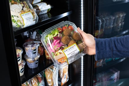 Employee buying salad from a office vending machine